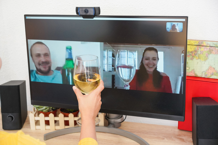 Young woman celebrating online chat meeting with friends - Focus on glass of wine