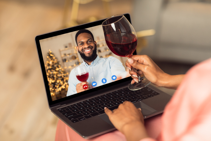 Online Date, Safe Meeting With Friends. Over The Shoulder View Of African American Woman Talking By Video Chat To Her Boyfriend Using Laptop And Drinking Red Wine. Stay Home. Social Distance.