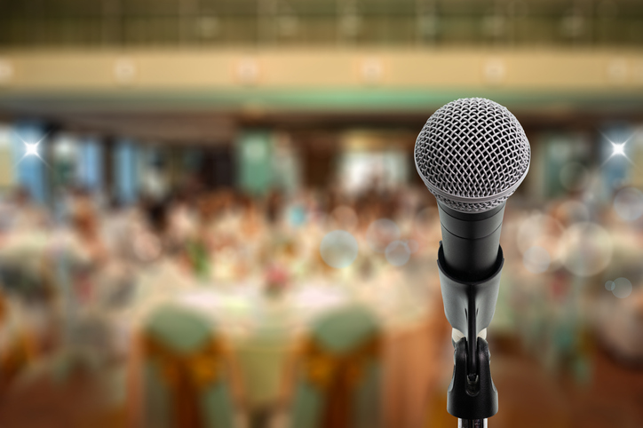 Close up microphone on stage in ball room. Let's talk