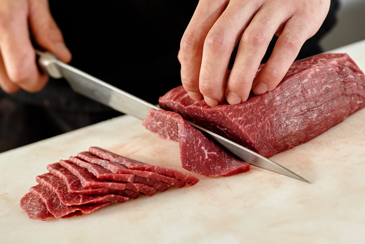 Japanese man slicing meat