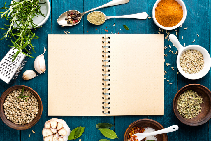 culinary background with spices and recipe book