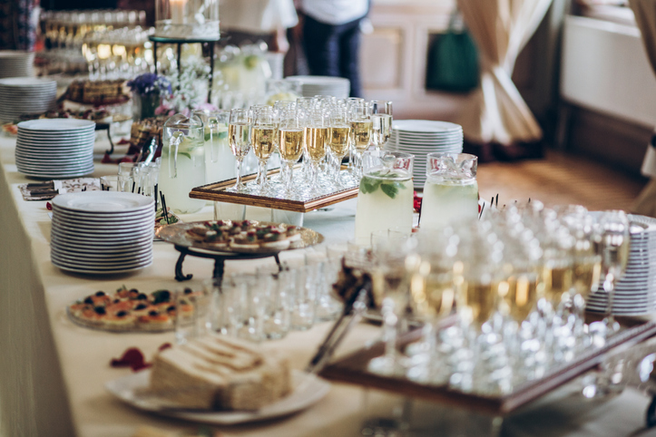stylish champagne glasses and food appetizers on table at wedding reception. luxury catering at celebrations. serving food and drinks at events concept
